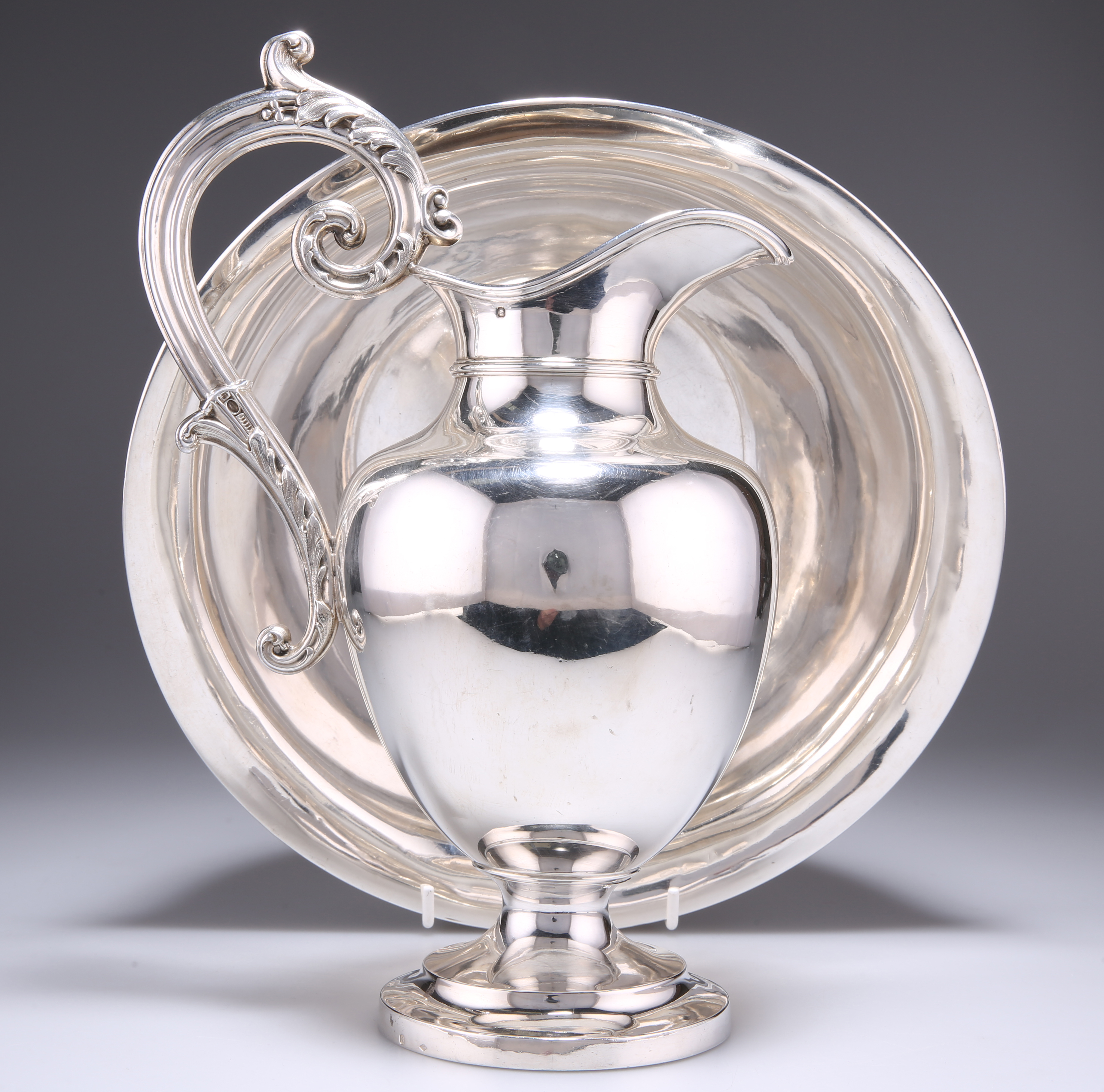 A FRENCH SILVER WATER EWER AND BASIN