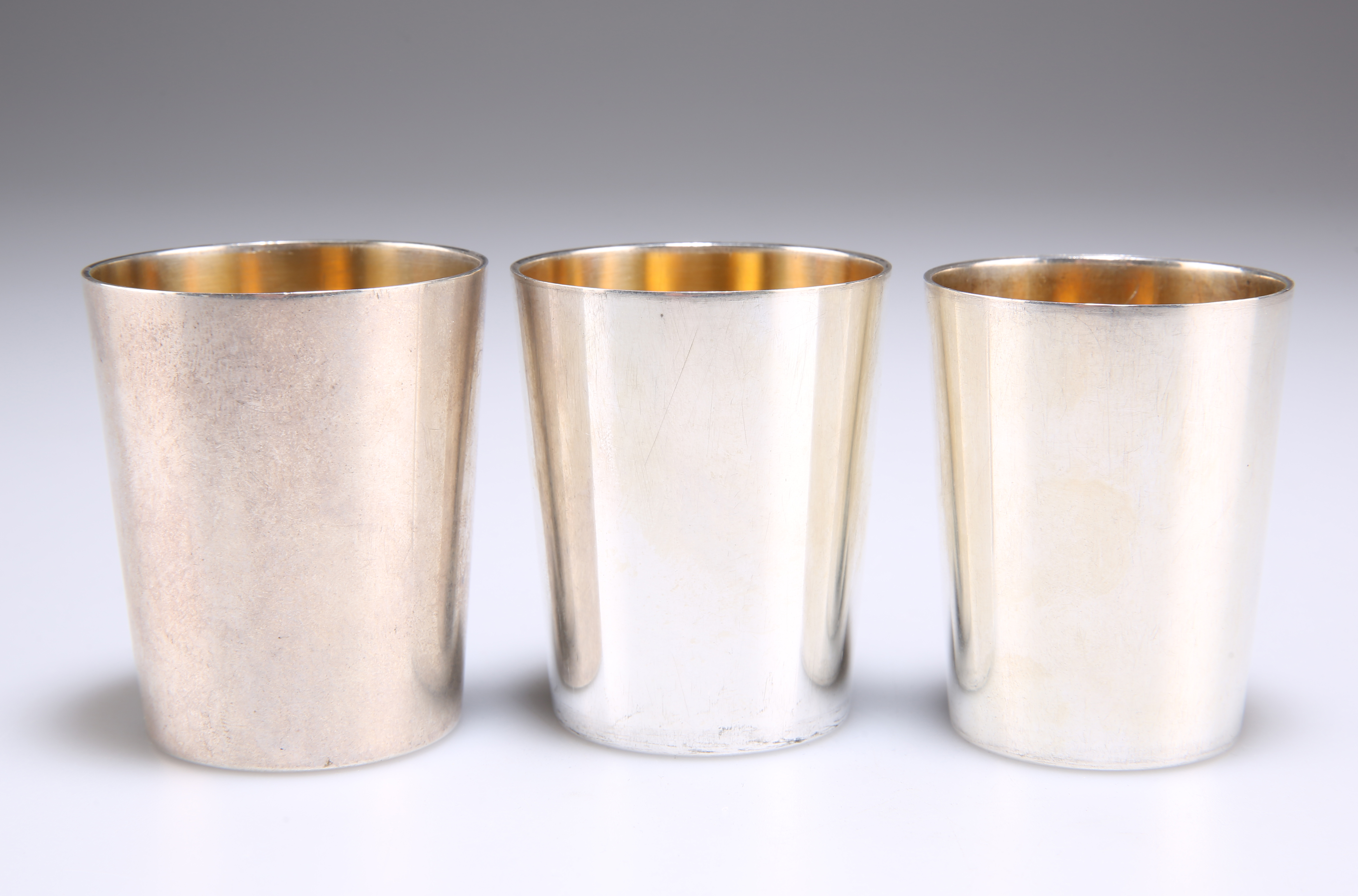 A SET OF THREE GERMAN SILVER STACKING BEAKER CUPS