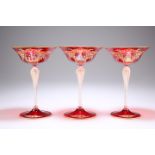 A SET OF THREE VENETIAN RUBY GLASS CHAMPAGNE COUPES