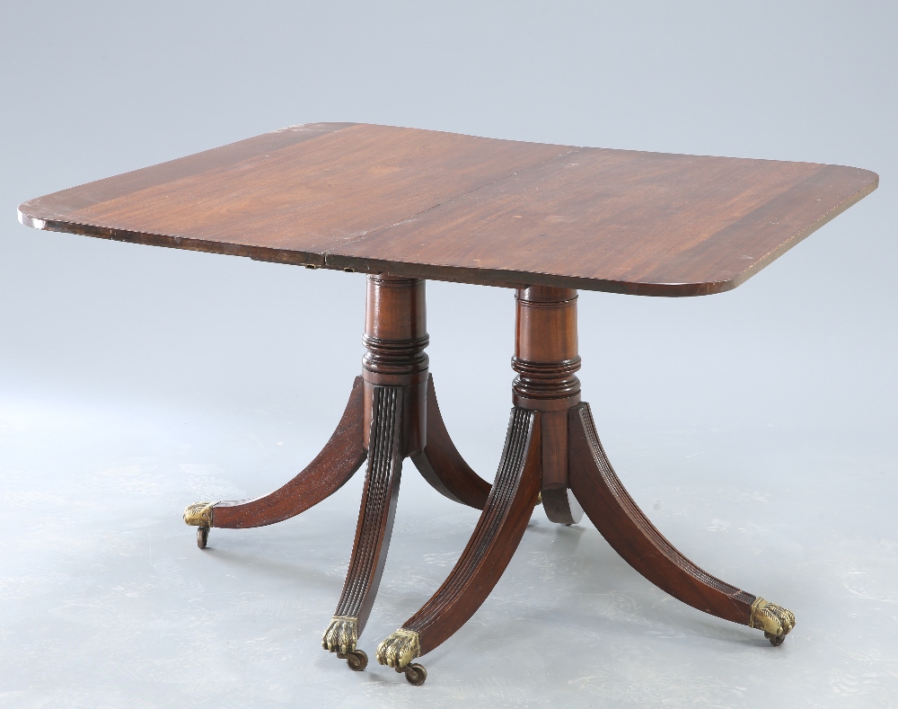 A GEORGE III STYLE MAHOGANY TWIN PEDESTAL DINING TABLE