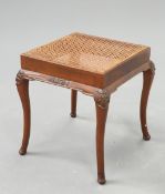 AN EARLY 20TH CENTURY WALNUT AND CANEWORK STOOL
