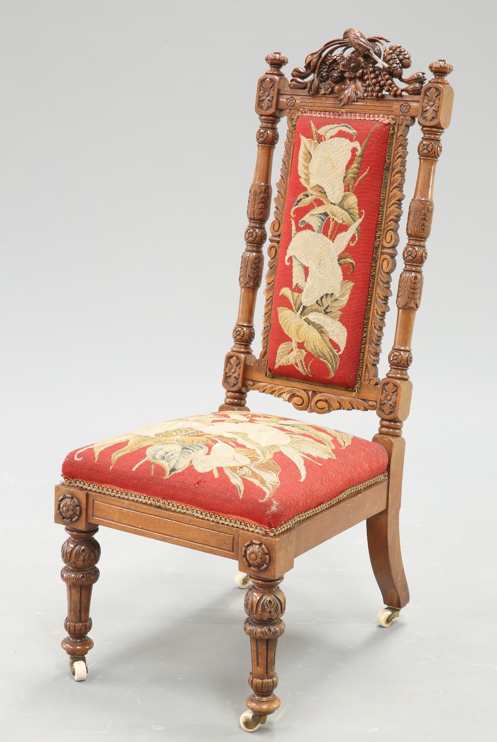 A 19TH CENTURY CARVED WALNUT AND NEEDLEWORK UPHOLSTERED PRIE-DIEU