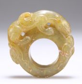 A CHINESE CARVED HARDSTONE RING OR TOGGLE