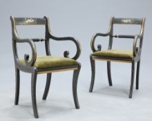 A PAIR OF REGENCY STYLE PAINTED AND GILDED OPEN ARMCHAIRS