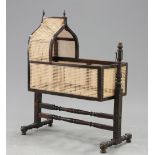 A 19TH CENTURY CANEWORK CRADLE