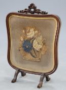 A 19TH MAHOGANY AND NEEDLEWORK FIRESCREEN