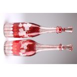 A PAIR OF BOHEMIAN RUBY FLASHED GLASS DECANTERS AND STOPPERS