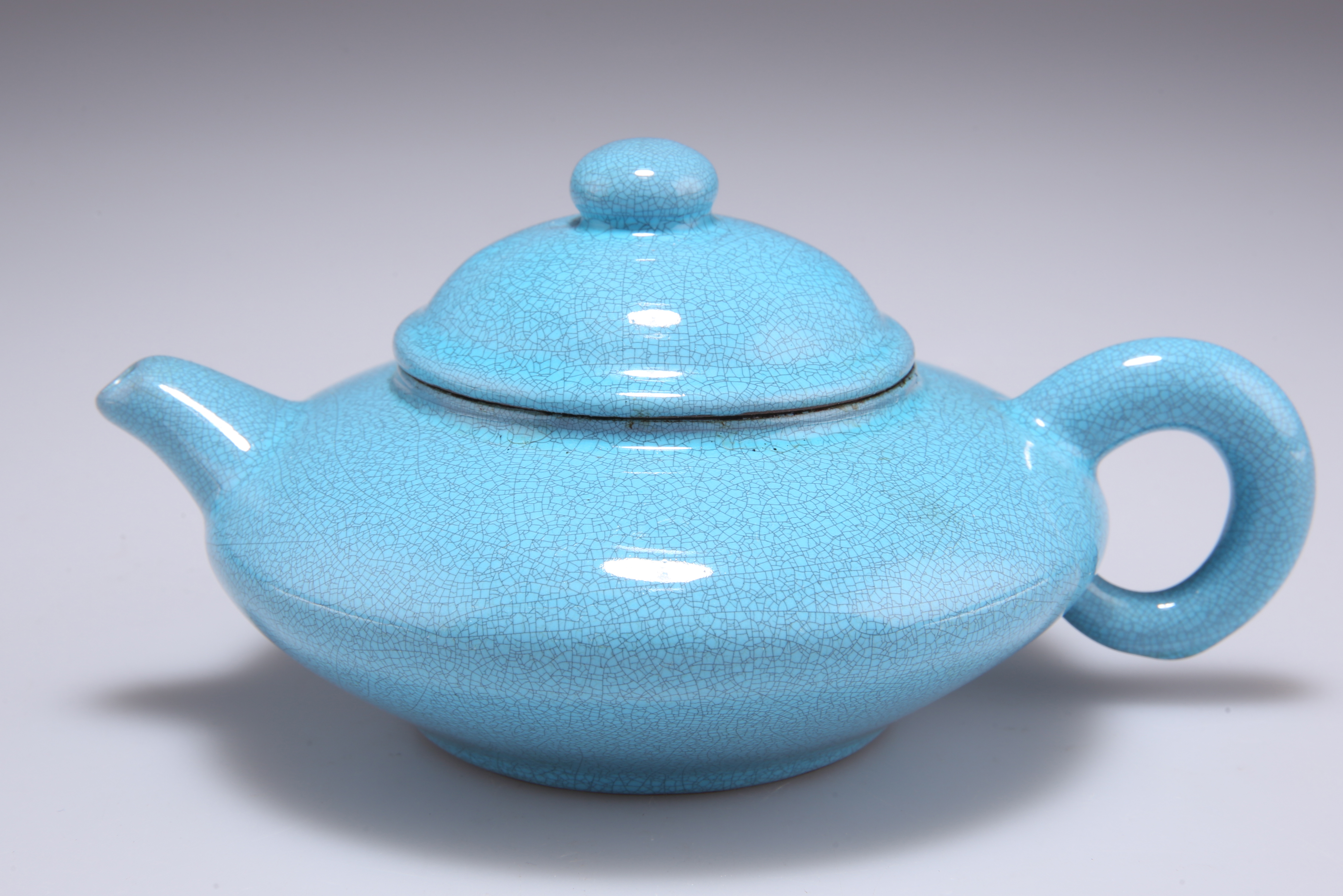 A CHINESE YIXING TURQUOISE CRACKLE GLAZED TEAPOT AND COVER