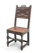 A 17TH CENTURY OAK PANEL-BACK CHAIR