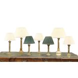 A GROUP OF SEVEN COUNTRY HOUSE BRASS COLUMNAR TABLE LAMPS