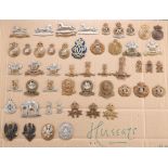 A COLLECTION OF CAP BADGES, COLLAR BADGES AND ARM BADGES