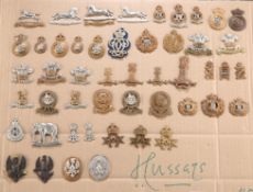 A COLLECTION OF CAP BADGES, COLLAR BADGES AND ARM BADGES