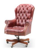 AN OXBLOOD LEATHER DEEP-BUTTONED SWIVEL DESK CHAIR