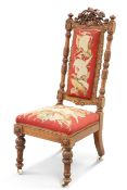 A 19TH CENTURY CARVED WALNUT AND NEEDLEWORK UPHOLSTERED PRIE-DIEU