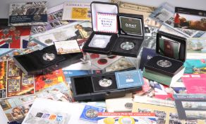 A LARGE COLLECTION OF ROYAL MINT AND OTHER COIN AND STAMP PACKS