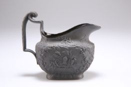 AN EARLY 19TH CENTURY BLACK BASALT CREAM JUG