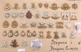 A COLLECTION OF CAP BADGES, COLLAR BADGES AND ARM BADGES