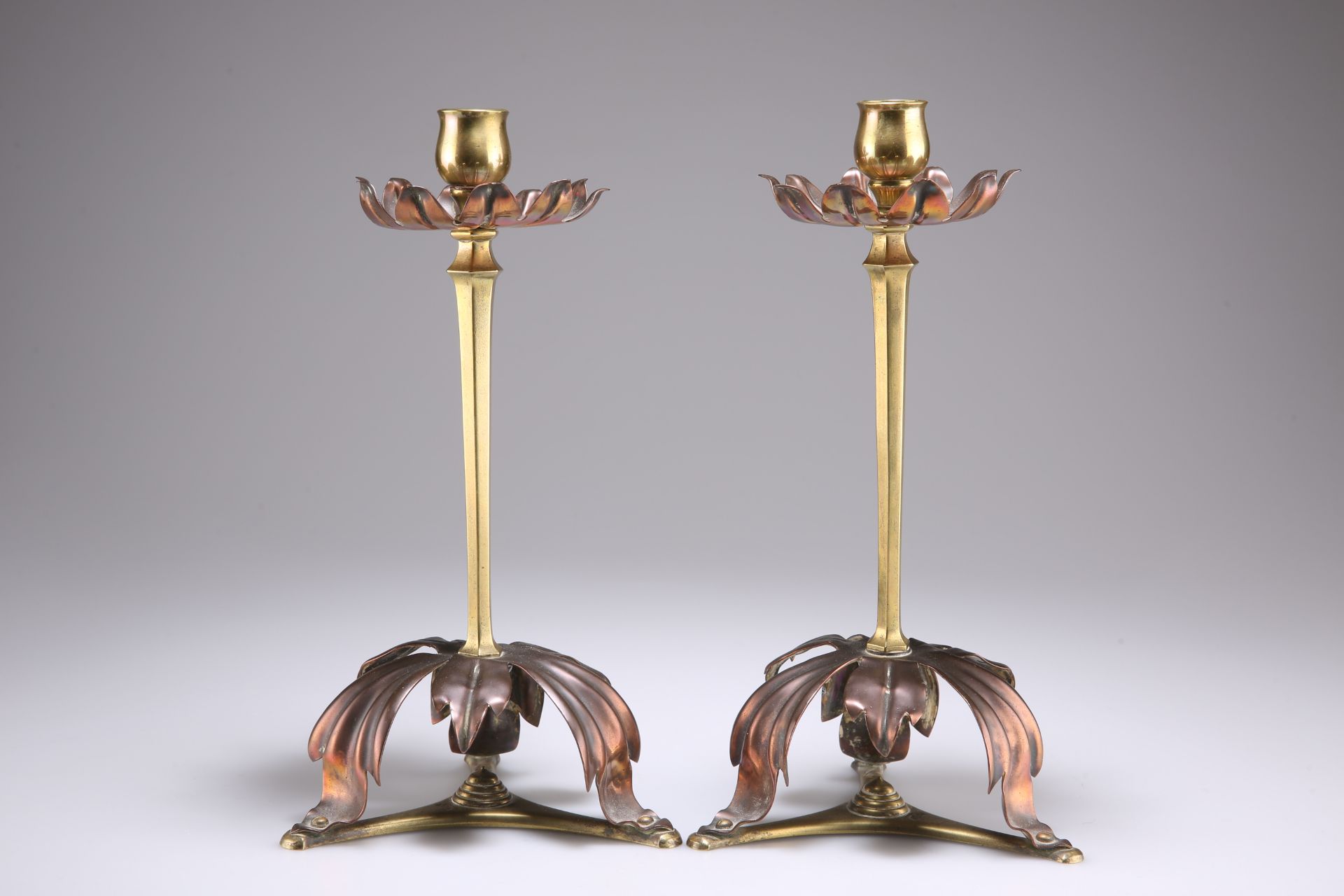 WILLIAM ARTHUR SMITH (W.A.S) BENSON (1854-1924), A PAIR OF ARTS & CRAFTS BRASS AND COPPER CANDLESTIC