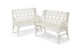 A PAIR OF WHITE PAINTED METAL "GOTHIC" GARDEN BENCHES