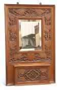 GIGGLESWICK SCHOOL, AN ARTS AND CRAFTS CARVED OAK HALL MIRROR CIRCA 1905