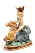 A MINTON MAJOLICA GROUP OF A PUTTO, CIRCA 1874