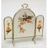 AN EARLY 20TH CENTURY BRASS AND MIRRORED FIRESCREEN