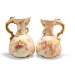 A NEAR PAIR OF ROYAL WORCESTER BLUSH IVORY JUGS