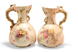 A NEAR PAIR OF ROYAL WORCESTER BLUSH IVORY JUGS