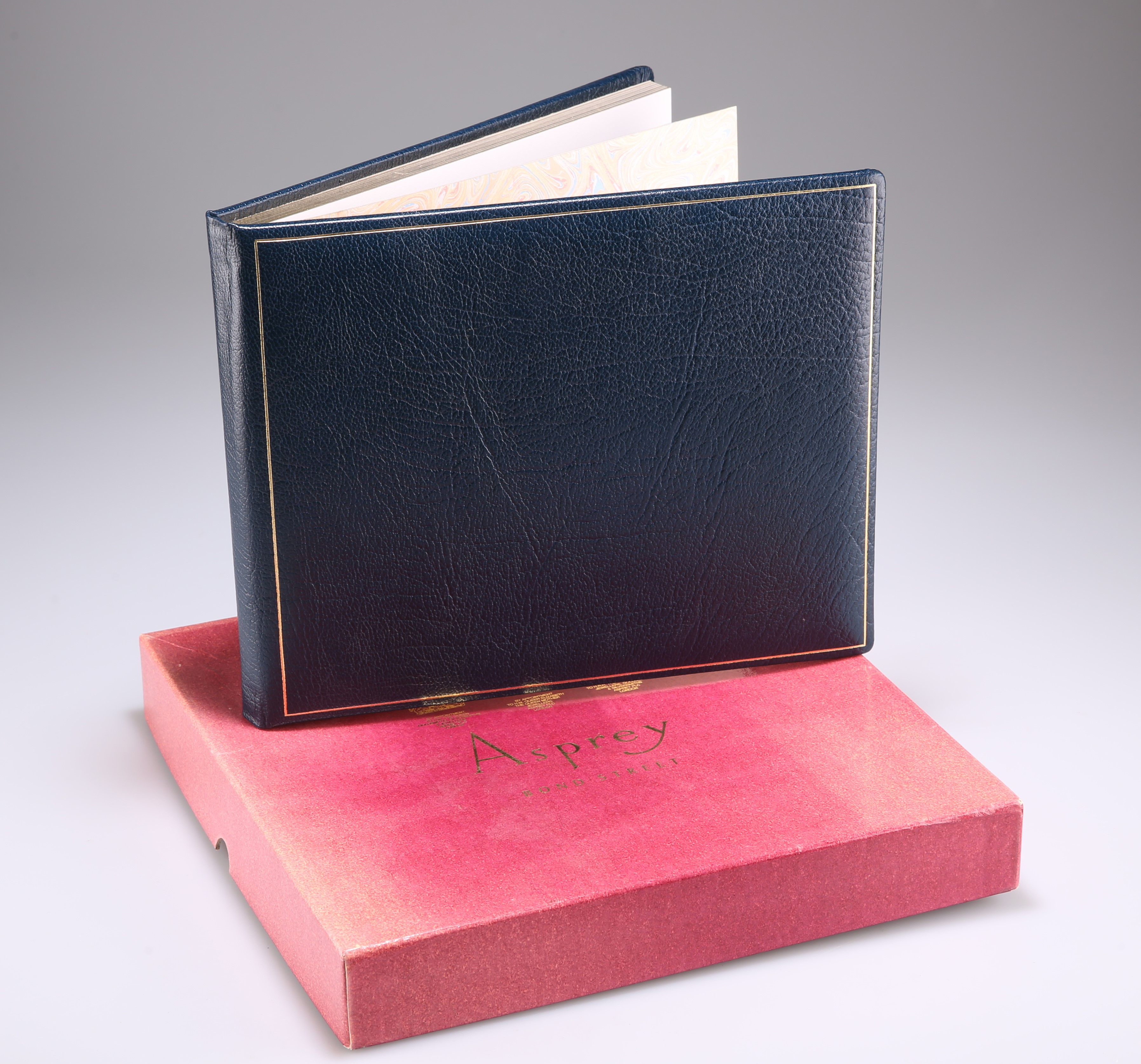 A BLUE AND TOOLED LEATHER BOUND VISITOR BOOK
