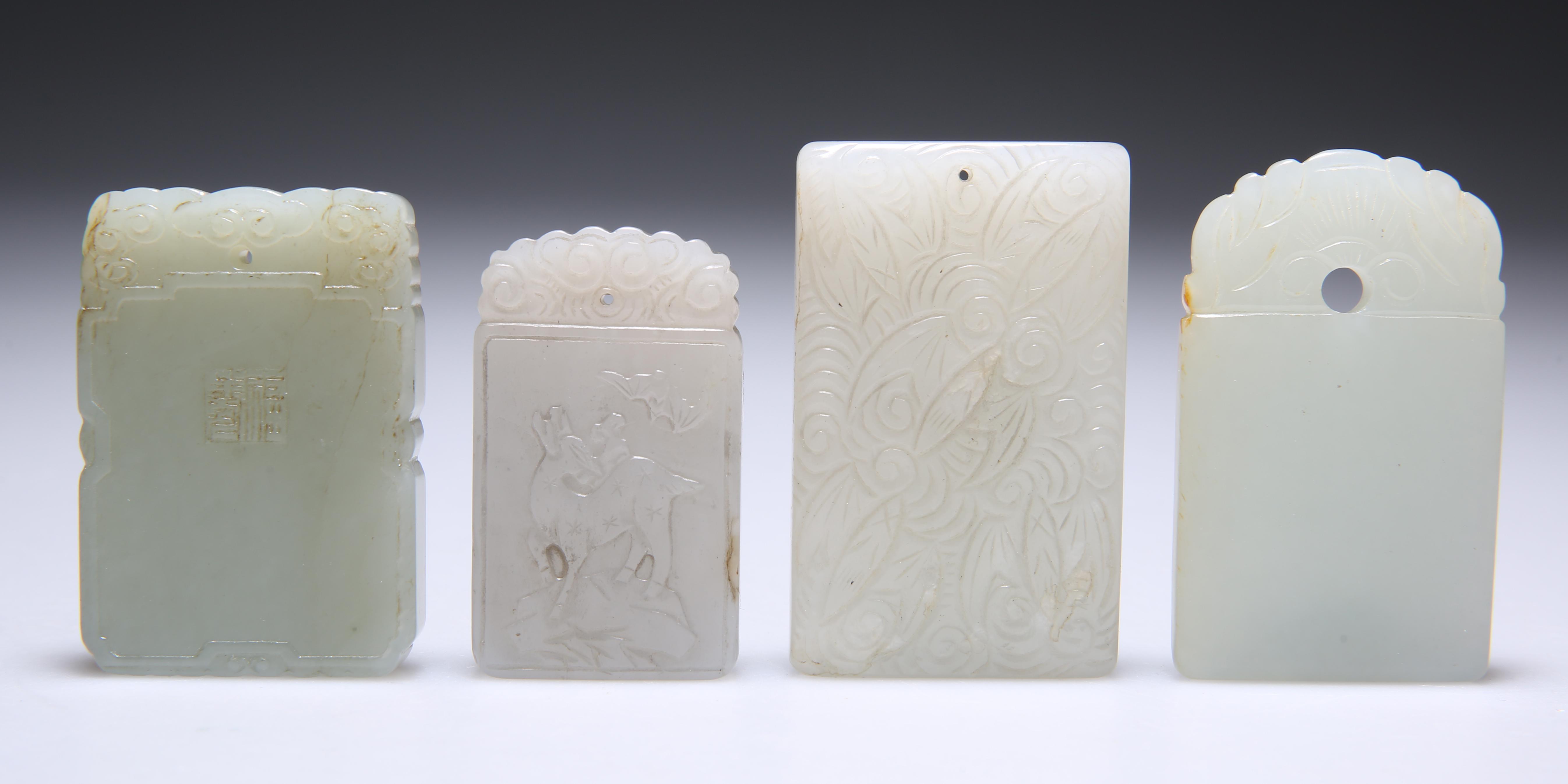 FOUR CHINESE CARVED JADE PENDANT