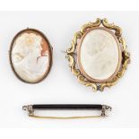 AN ONYX AND DIAMOND BAR BROOCH AND TWO CAMEO BROOCHES