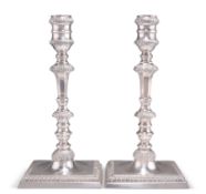 A PAIR OF GEORGE III STYLE CAST SILVER CANDLESTICKS