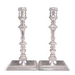 A PAIR OF GEORGE III STYLE CAST SILVER CANDLESTICKS