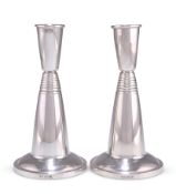 A PAIR OF MODERNIST SILVER CANDLESTICKS