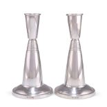 A PAIR OF MODERNIST SILVER CANDLESTICKS