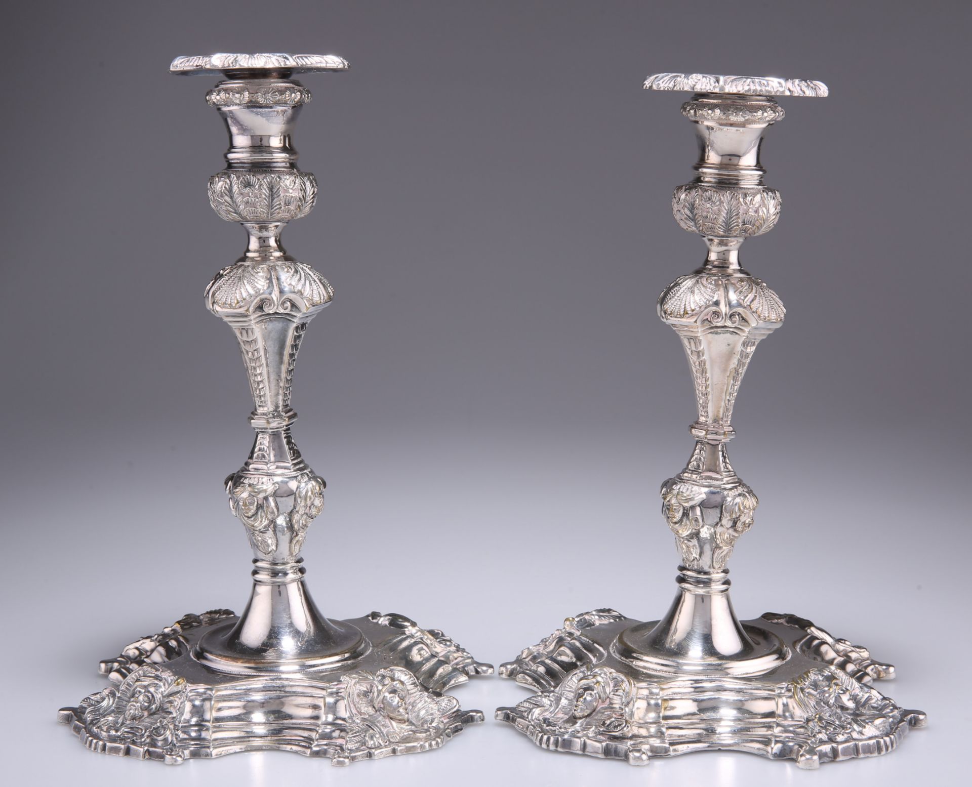 A PAIR OF BAROQUE REVIVAL SILVER-PLATED CANDLESTICKS