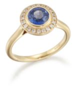 AN 18 CARAT GOLD SAPPHIRE AND DIAMOND CLUSTER RING