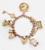 A 9 CARAT GOLD CHARM BRACELET