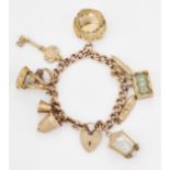 A 9 CARAT GOLD CHARM BRACELET