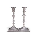 A PAIR OF GEORGE III CAST SILVER CANDLESTICKS