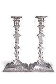 A PAIR OF GEORGE III CAST SILVER CANDLESTICKS