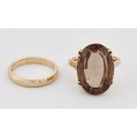 A SMOKY QUARTZ RING AND A 9 CARAT GOLD BAND RING
