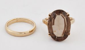 A SMOKY QUARTZ RING AND A 9 CARAT GOLD BAND RING