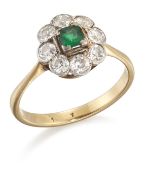 AN EMERALD AND DIAMOND CLUSTER RING