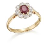 AN 18 CARAT GOLD RUBY AND DIAMOND CLUSTER RING