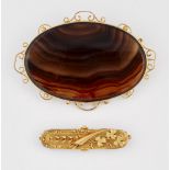A VICTORIAN BANDED AGATE BROOCH AND A LATE VICTORIAN BROOCH