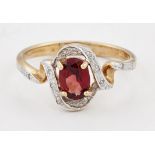 A 9 CARAT GOLD GARNET AND DIAMOND RING