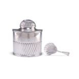 AN EDWARDIAN SILVER TEA CADDY AND SPOON