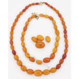 A GRADUATED AMBER BEAD NECKLACE; AND A BROKEN STRAND OF GRADUATED AMBER BEADS