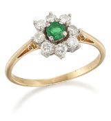 AN EMERALD AND DIAMOND CLUSTER RING